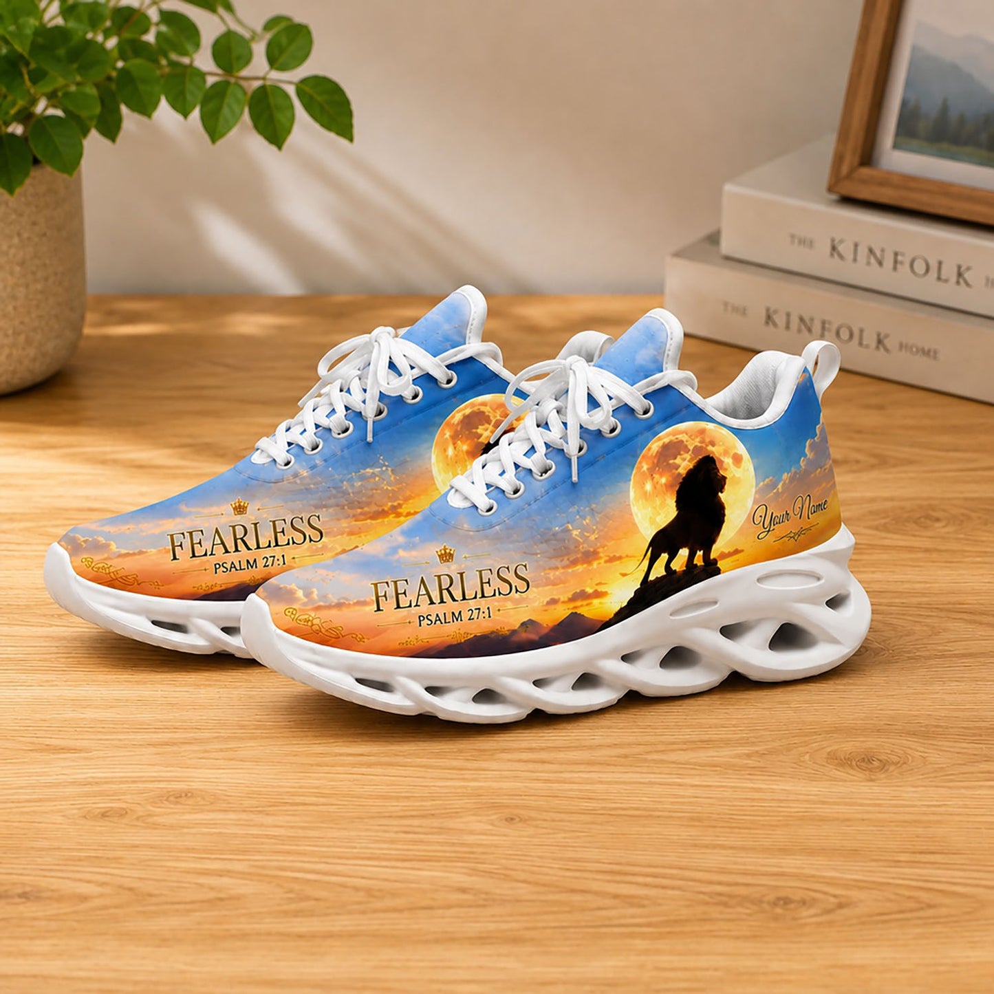 Lifestyle display of Christian lion Max Soul shoes with white soles styled on a wooden table setup