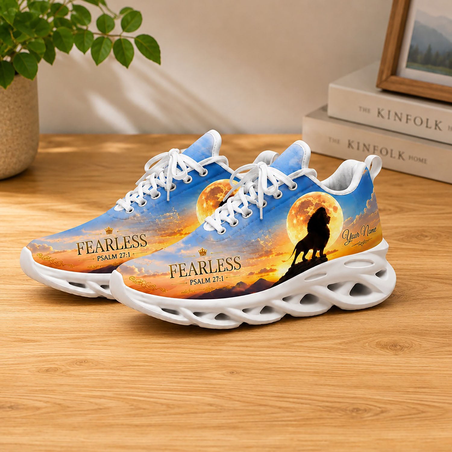 Lifestyle display of Christian lion Max Soul shoes with white soles styled on a wooden table setup