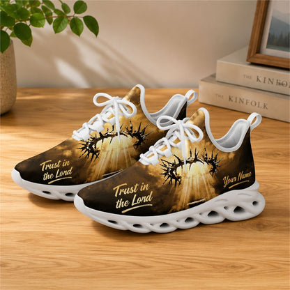 Lifestyle view of white-soled faith sneakers on wood, displaying the personalized name zone and gold script text
