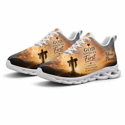 Angled pair of Christian holy cross sneakers with golden sunset sky and 1 John 4:19 scripture on white soles