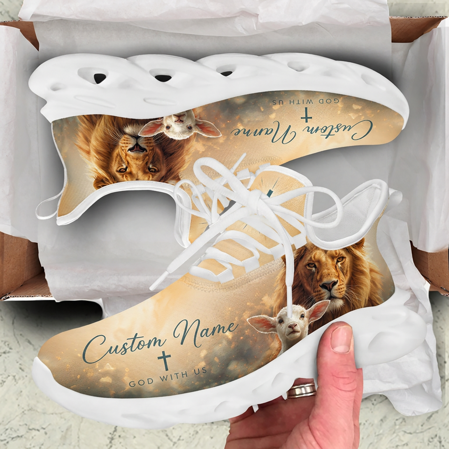 Unboxing display of the Christian beige sneakers featuring the Lion and Lamb motif inside a cardboard package box
