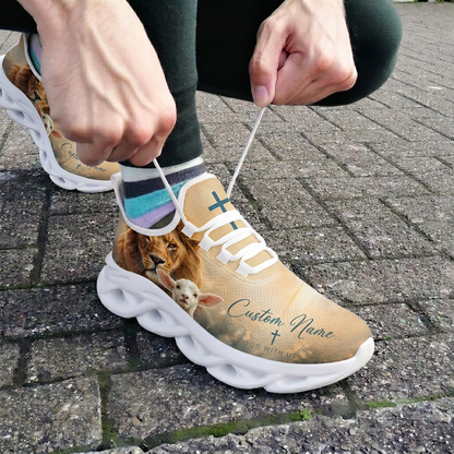 Close-up view of a person lacing up the white custom God With Us athletic shoes on an outdoor pavement background