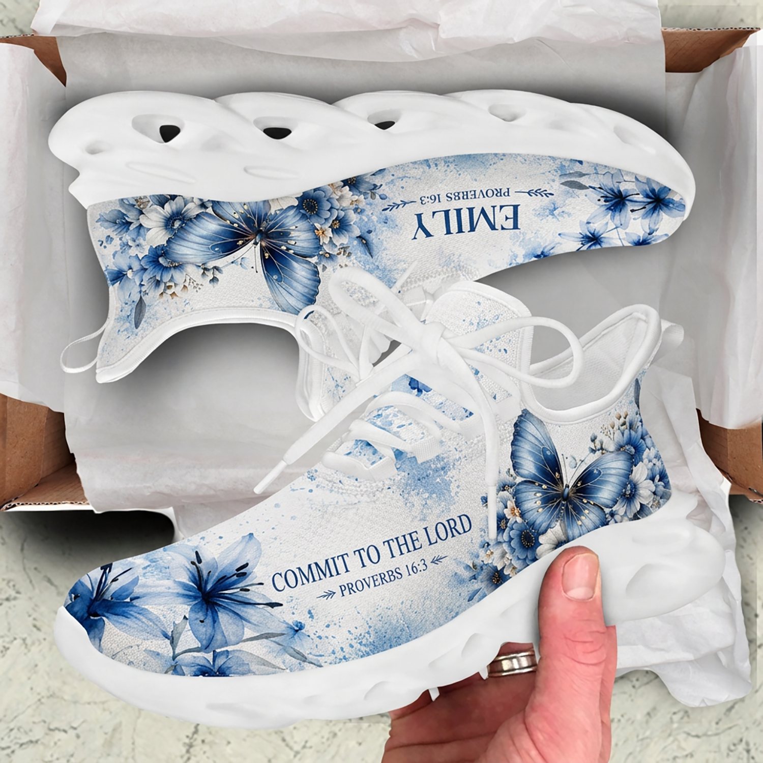 Top-down view of the custom sneakers showcasing the blue floral watercolor patterns and butterfly icons on the insoles