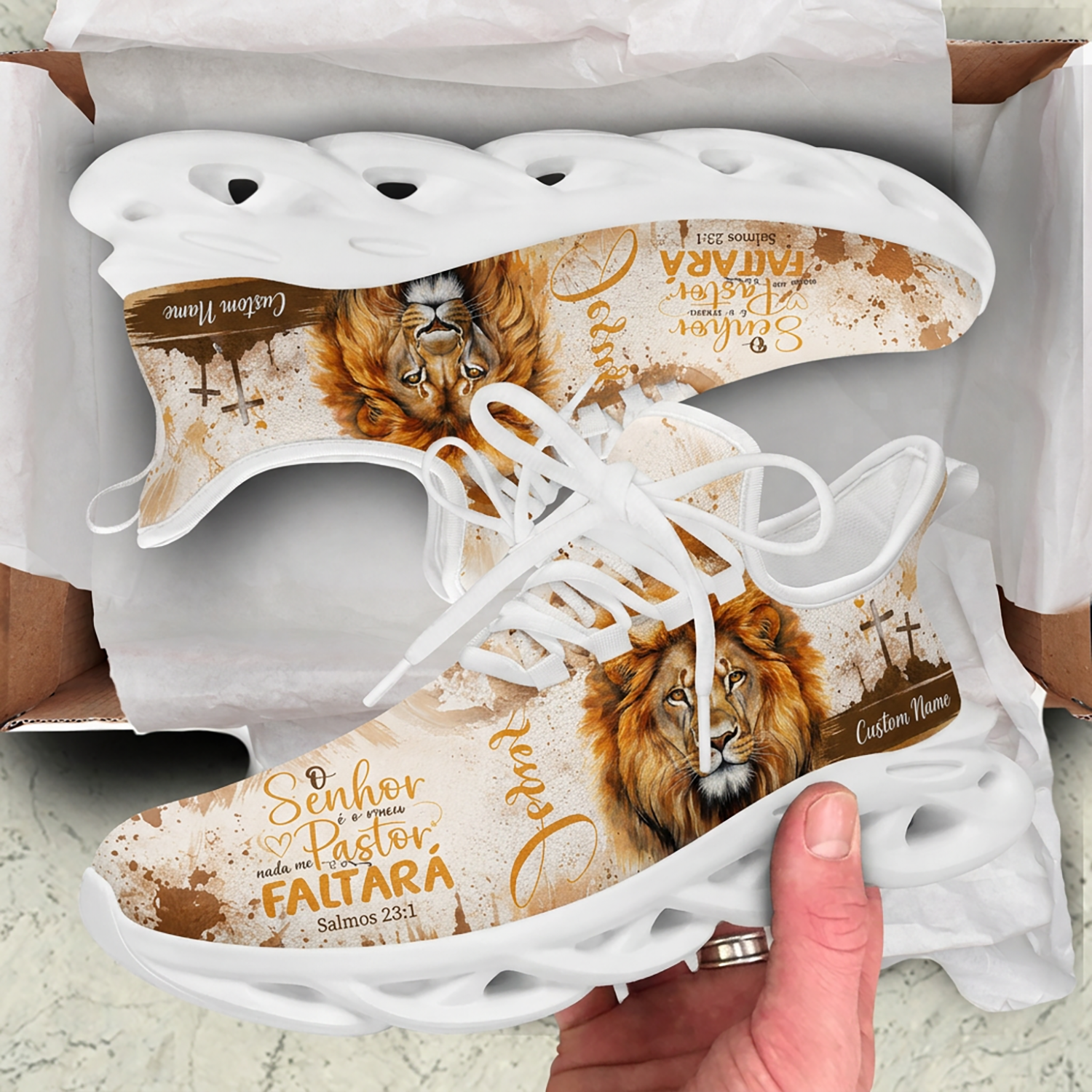 Top-down view of Portuguese Christian lion sneakers inside a cardboard unboxing presentation