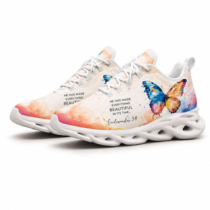 Angled pair of watercolor butterfly sneakers with vibrant color splashes and Ecclesiastes 3:11 scripture on white soles