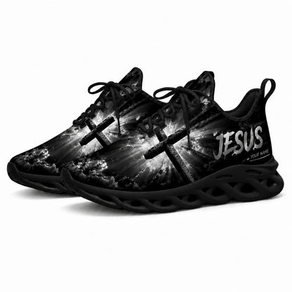 Angled studio shot of black-soled religious footwear featuring the glowing cross design