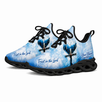 Angled studio shot of black-soled religious sneakers highlighting the modern blue faith scripture artwork