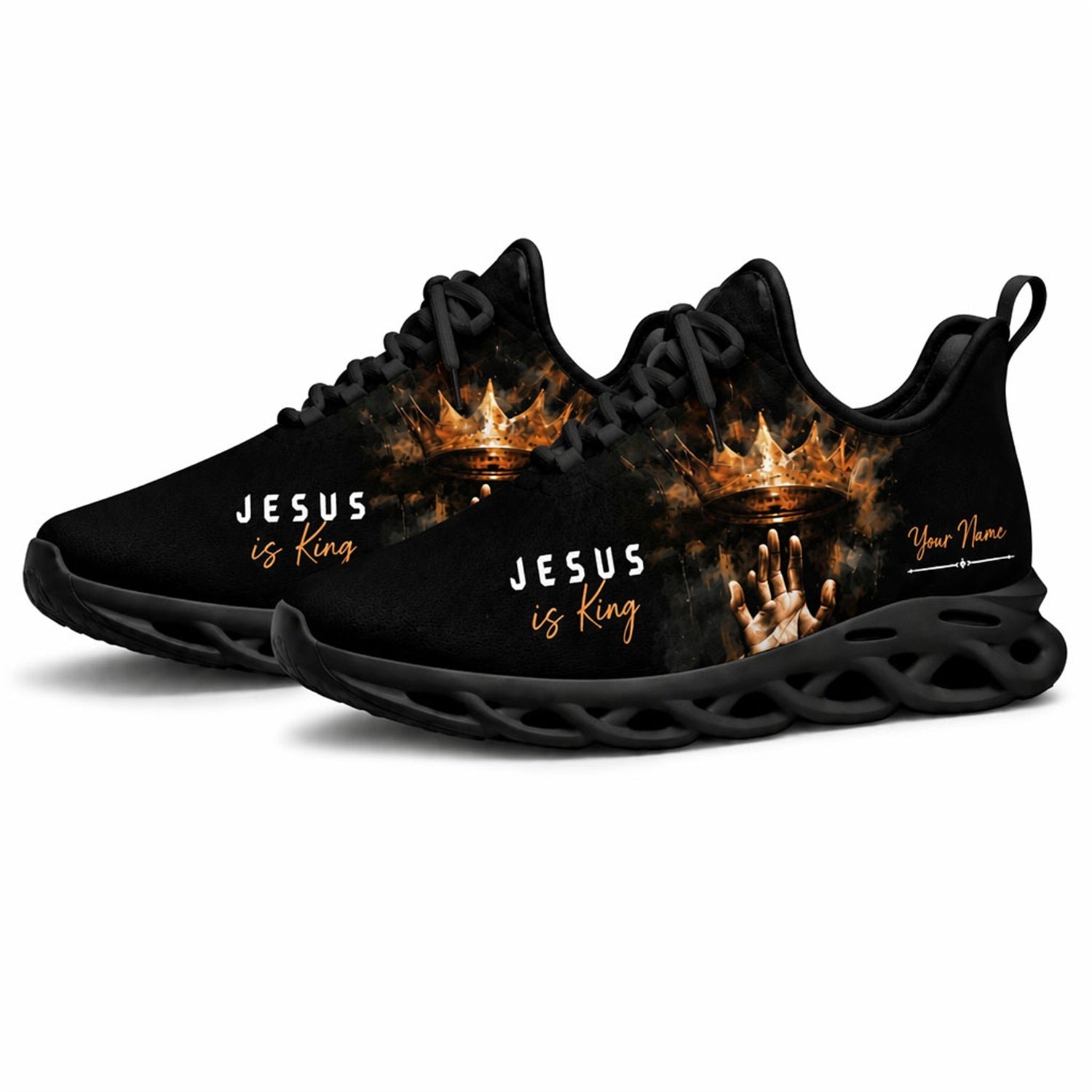 Angled studio shot of black-soled religious footwear highlighting the golden crown design