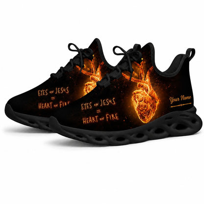 Angled studio shot of black-soled religious footwear highlighting the burning heart graphic
