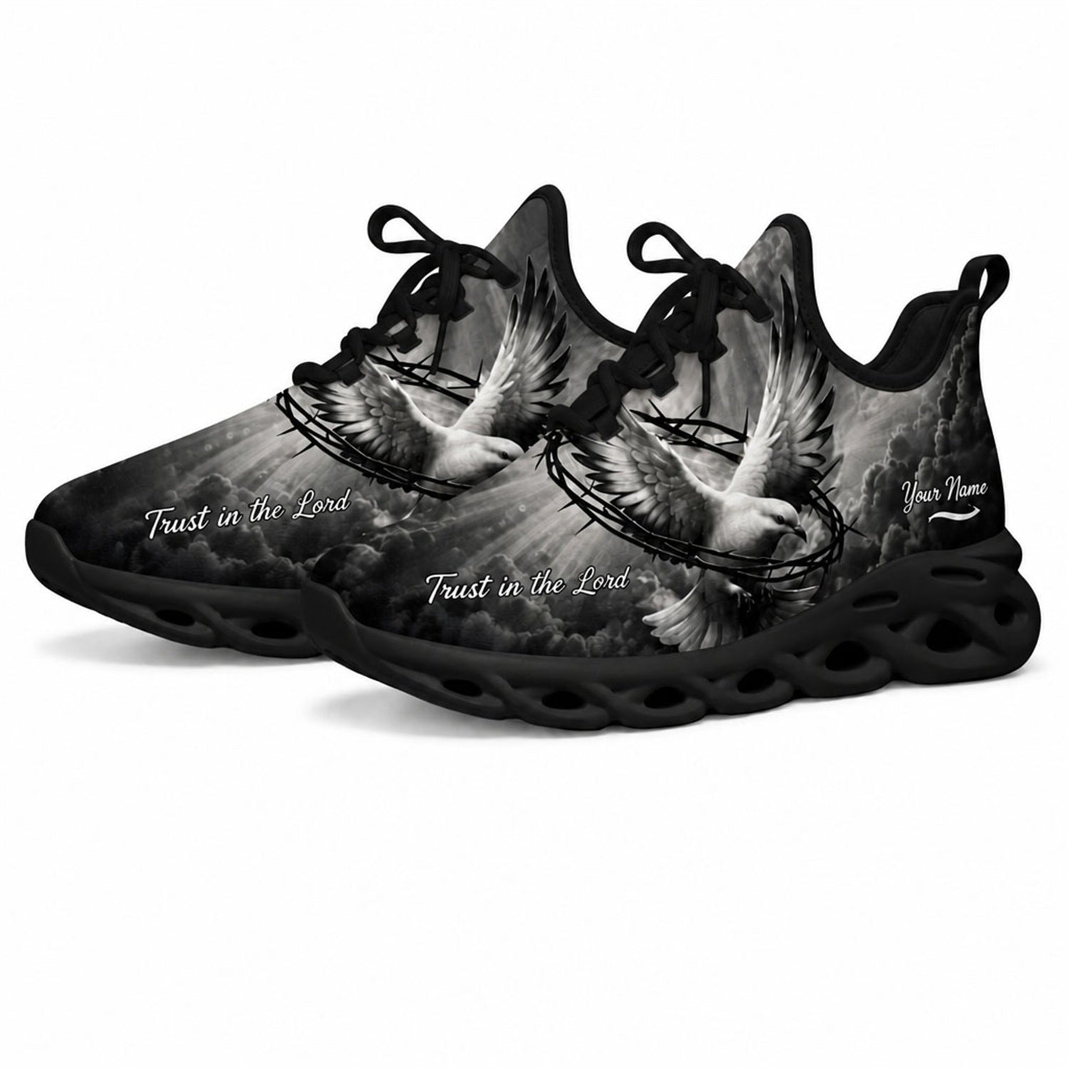 Angled studio shot of black wavy sole religious sneakers showing grayscale heavenly clouds and sunrays
