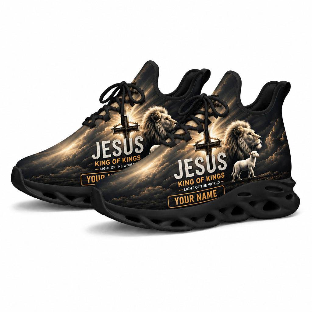 Angled shot of the black-soled religious athletic sneakers highlighting the golden sunburst cross design and "Light of the World" text