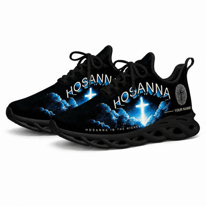Angled studio shot of black-soled religious sneakers highlighting the bright glowing faith cross design