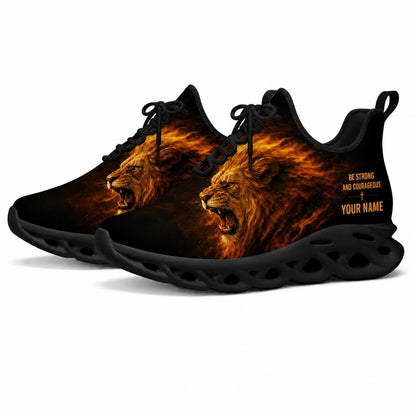 Angled studio shot of black-soled religious sneakers highlighting the blazing lion graphics