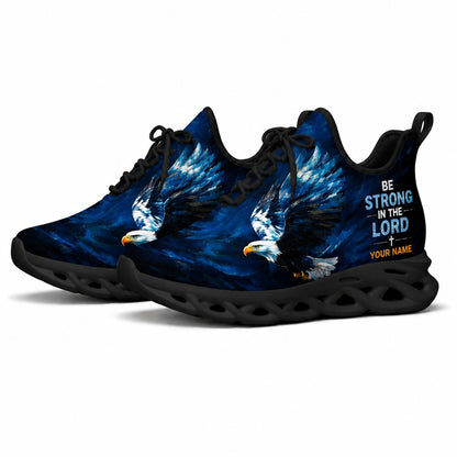 Angled shot of black-soled religious sneakers highlighting the Be Strong In The Lord scripture typography